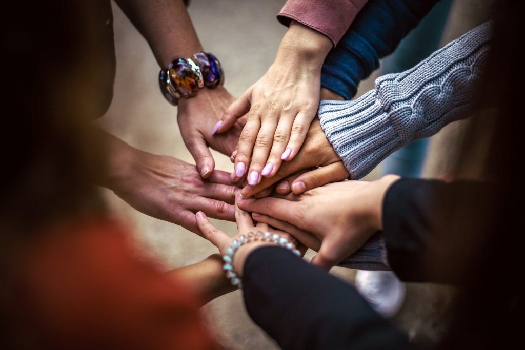 group of people connecting hands