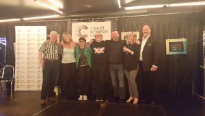 Image of group of people in front of cancer research banner
